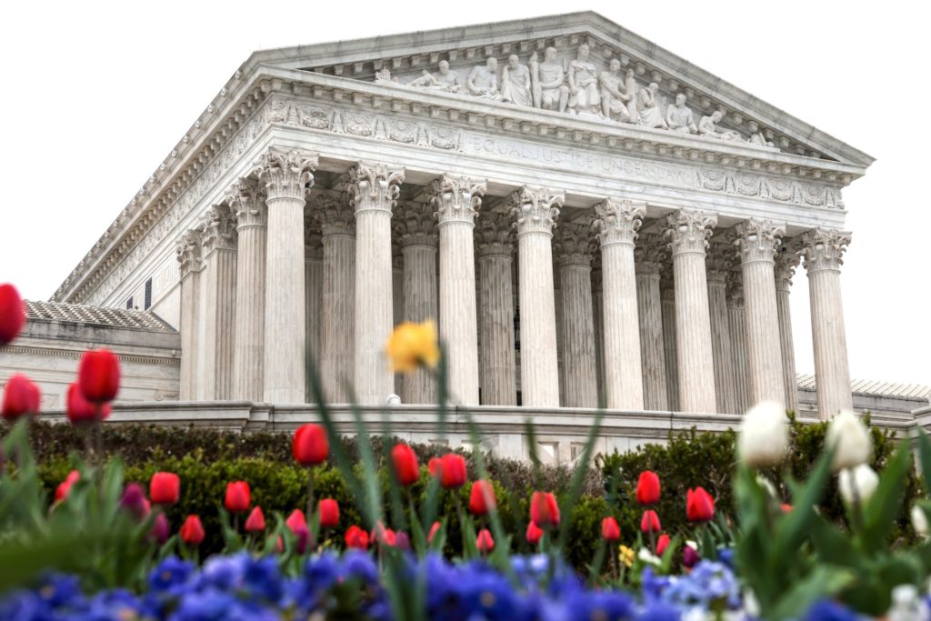 Flowers bloom in front of the U.S. Supreme Court building during proceedings in Washington