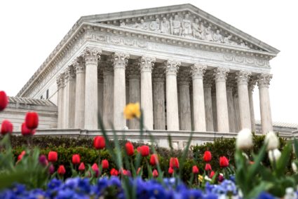 Flowers bloom in front of the U.S. Supreme Court building during proceedings in Washington