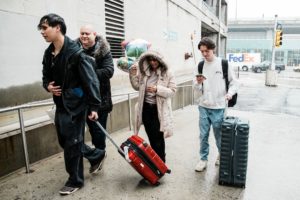 People arrive via U.S. government chartered flight at John F. Kennedy (JFK) International Airport in New York