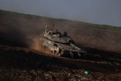 An Israeli tank manoeuvers on the Israeli side of the Lebanese-Israeli border, amid escalation between Hezbollah and Israe...