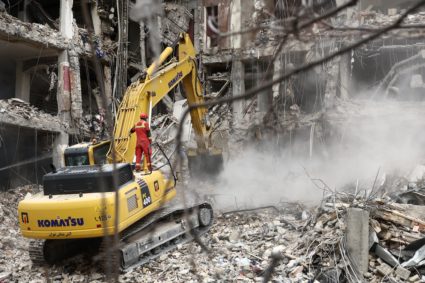 Emergency personnel work at the site of a strike on a residential building, in Tehran