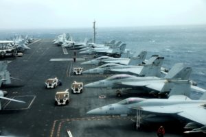 FILE PHOTO: F/A-18F aircrafts are seen on the deck of USS Abraham Lincoln in the Gulf of Oman near the Strait of Hormuz