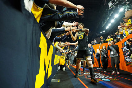 In NCAA men's championship, a Michigan team on a roll tries to derail a UConn dynasty
