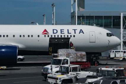 FILE PHOTO: A staff uploads packages on Delta Air Lines plane at John F. Kennedy International Airport in Queens, New York...