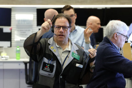 Traders work on the floor of the NYSE in New York