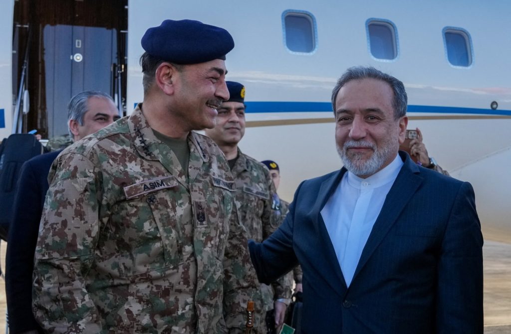 Iranian Foreign Minister Abbas Araqchi welcomes Pakistan army chief Asim Munir at an airport in Tehran