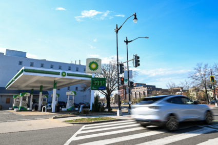 FILE PHOTO: Cars pass a gas station in Washington DC