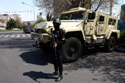 A member of a police force stands guard on a street, amid the U.S.-Israeli conflict with Iran, in Tehran