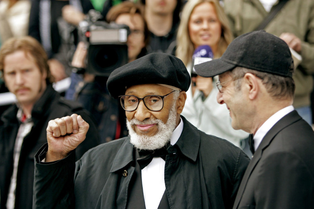 U.S. composer and musician Sonny Rollins clenches his fist as he and his compatriot Steve Reich arrive at the Concert Hall...
