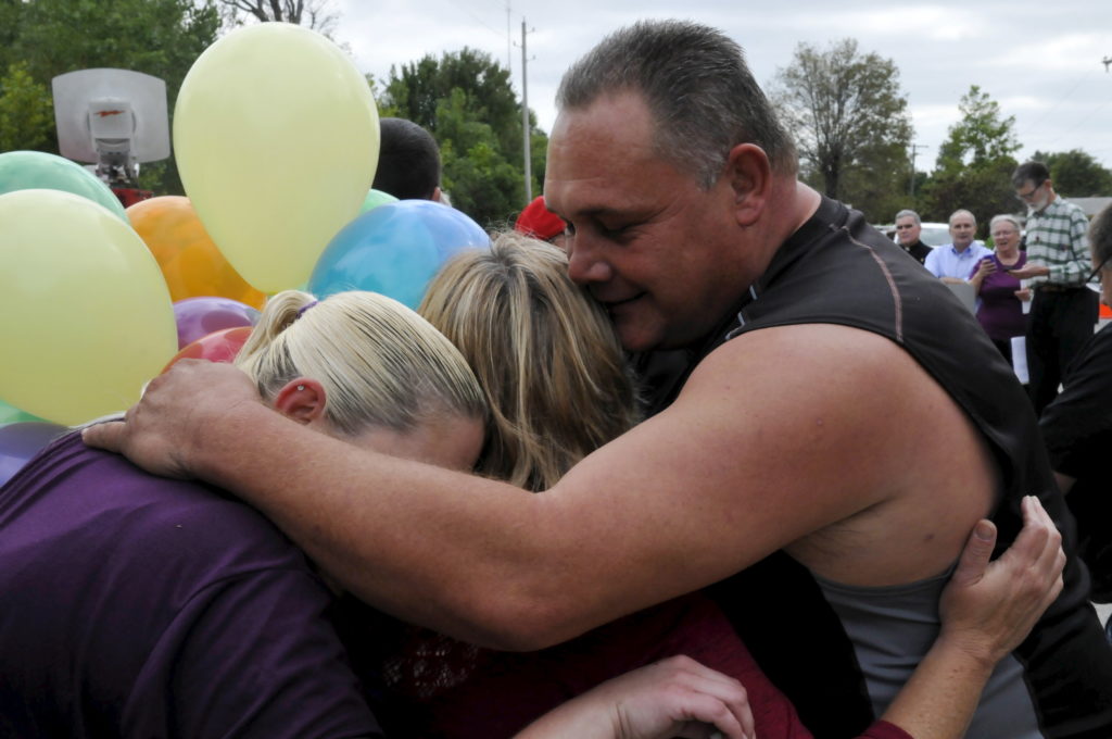 Protestors and family members embrace after hearing the news of Governor Fallin issuing a stay for death row inmate Richar...