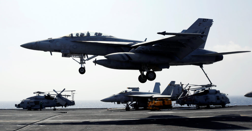 A U.S. Navy F18 fighter jet lands on the deck of aircraft carrier USS Carl Vinson in South China Sea