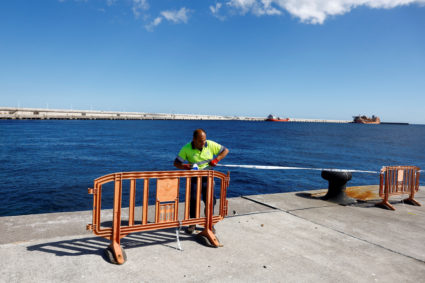 Workers prepare security measures at the port of Granadilla de Abona
