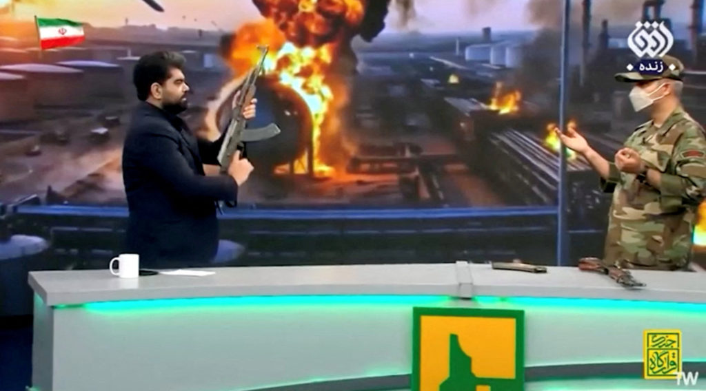 Iranian State News presenter fires gun at UAE flag during live broadcast
