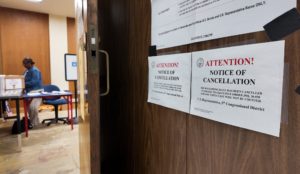 Signs inside an early voting location inform voters of a cancelled U.S. House race, in Baton Rouge