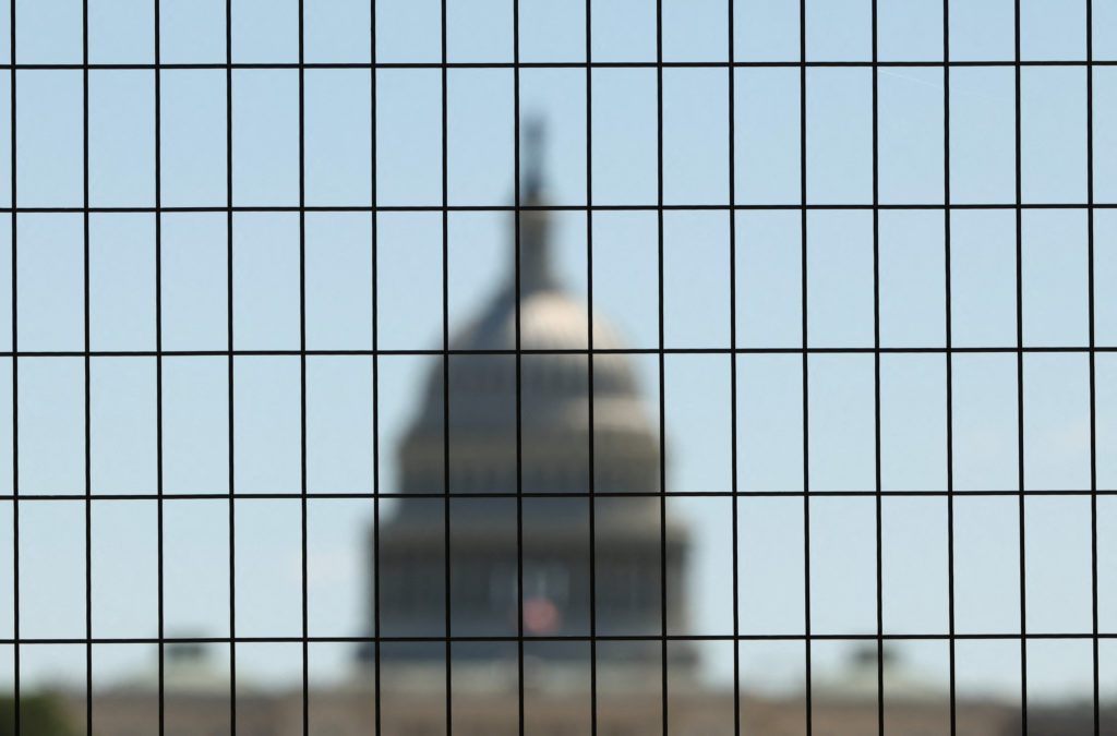 Dome of the U.S. Capitol seen through construction fencing as preparations for Freedom 250 continue along the National Mal...