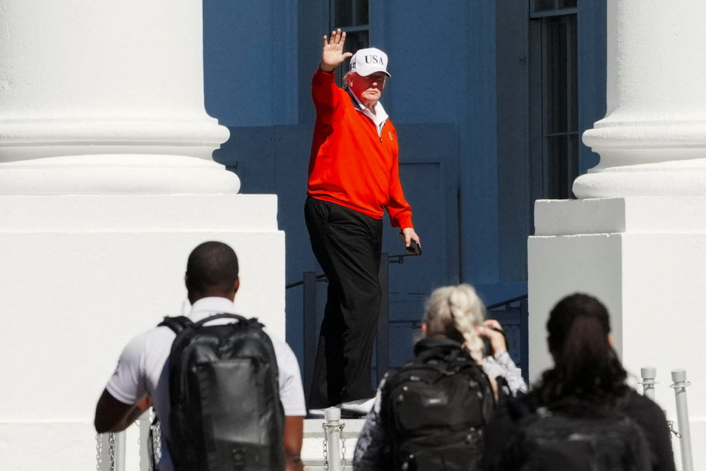 U.S. President Donald Trump waves as he returns to the White House, in Washington