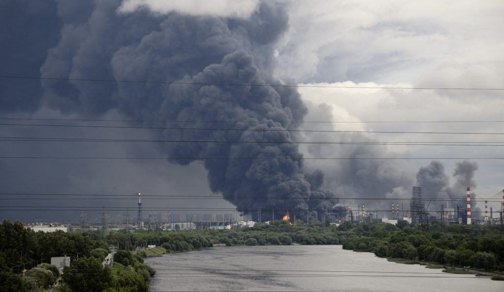 Thick plumes of smoke with flames rise from an oil refinery following a Ukrainian drone attack in Moscow