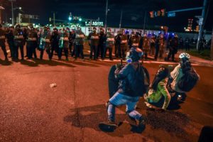 Protesters demonstrate in front of ICE officers outside Delaney Hall in Newark