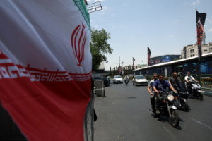 People drive on a street in Tehran