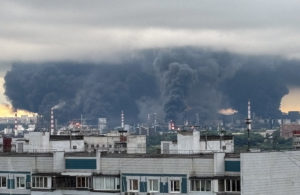 Thick plumes of smoke with flames rise from an oil refinery in Moscow