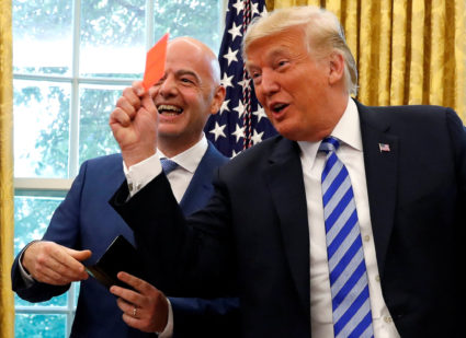 FILE PHOTO: U.S. President Donald Trump holds red card as he meets with FIFA President Infantino in the Oval Office of the...