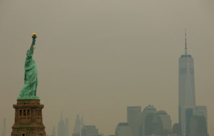 The Statue of Liberty and One World Trade Center in New York Cirty are seen through a cover of wildfire smoke in from New ...