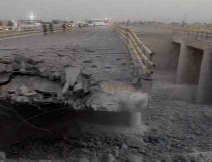A damaged portion of a bridge in the aftermath of a strike, in Bandar Khamir