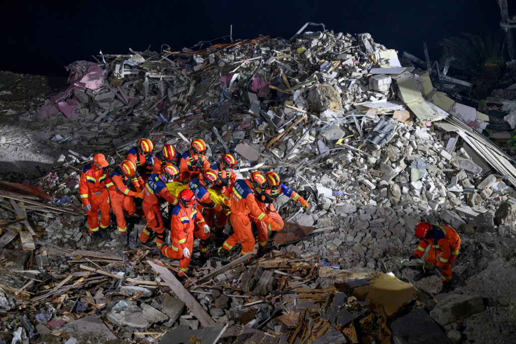 Rescue workers search for survivors at the site of a landslide in Chongqing
