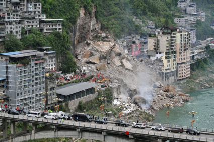 Rescue workers search for survivors at the site of a landslide in Chongqing