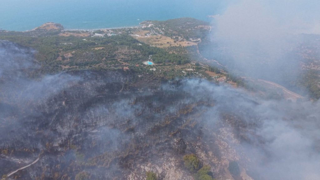 An aerial view shows smoke rising from a wildfire in Gargano