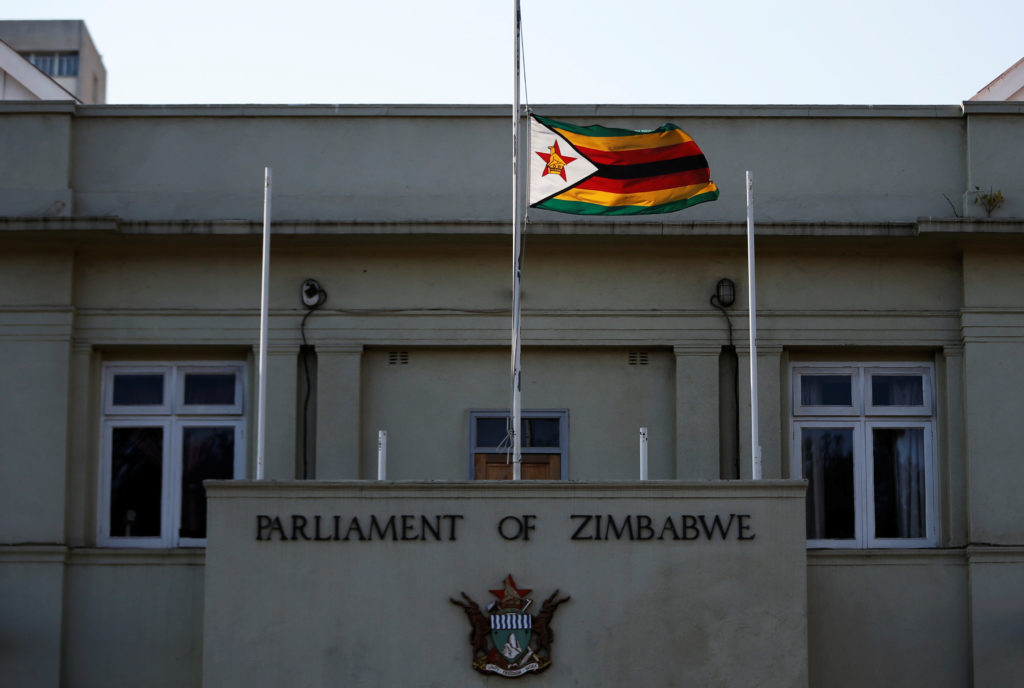 A flag is flown at half of a mast outside Paliament as Zimbabweans mourn the death of their founding father Robert Mugabe ...