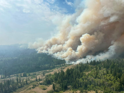 Smoke rises from the Pear Lake wildfire, which has caused the evacuation of the village of Clinton