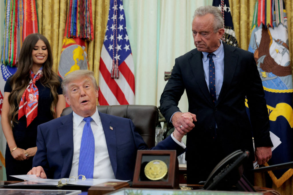 U.S. President Donald Trump signs an executive order in the Oval Office at the White House in Washington