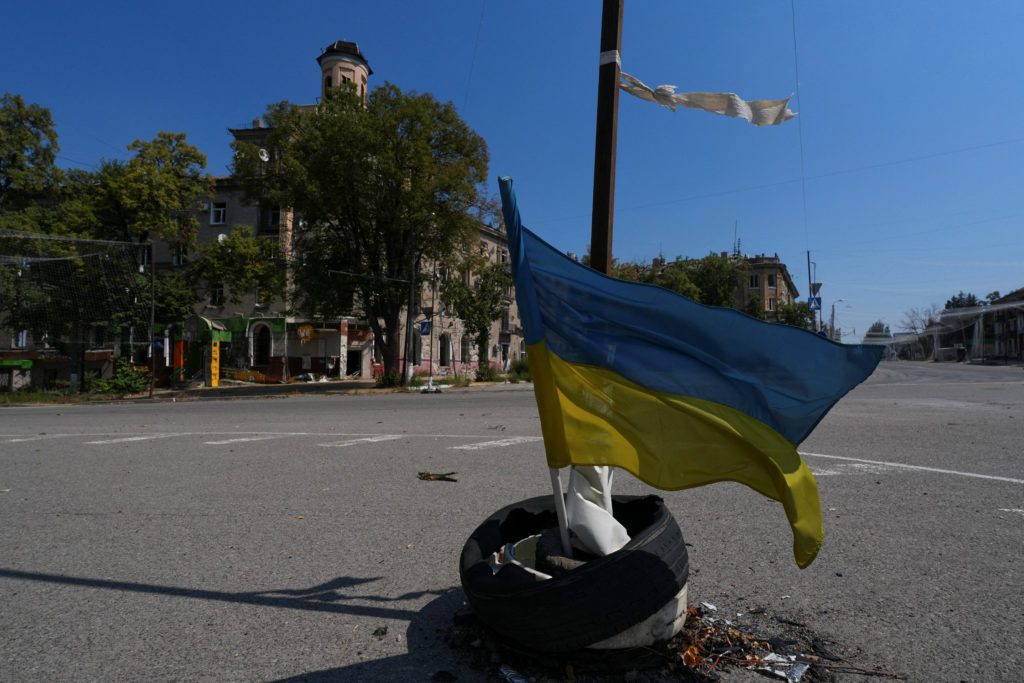 Ukrainian national flag waves on a street in the centre of the frontline town of Druzhkivka