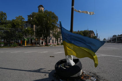 Ukrainian national flag waves on a street in the centre of the frontline town of Druzhkivka