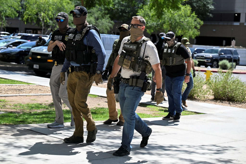 FILE PHOTO: Law enforcement officers, including HSI and ICE agents take people into custody at an immigration court in Pho...
