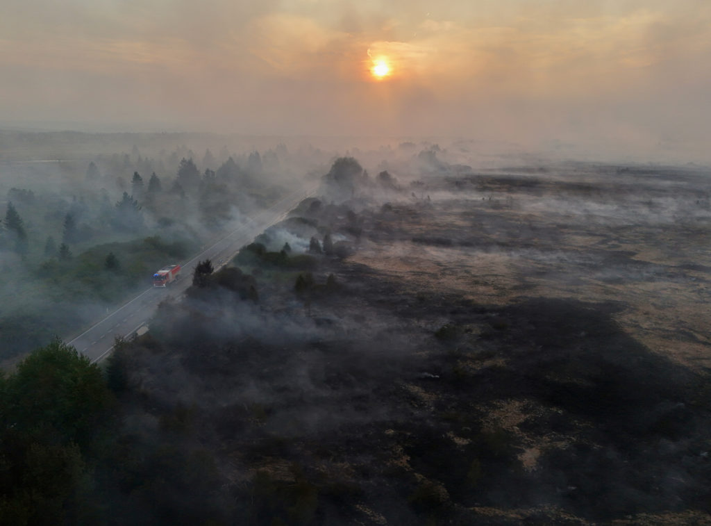 Firefighters battle massive wildfires in Belgium and Greece as 2 die on an island near Athens