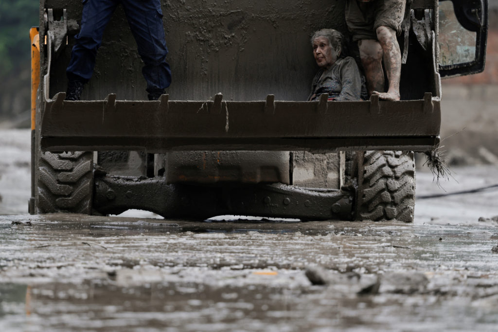 A survivor is transported to a safer place in a JCB following a flash flood at Trishuli, Nepal