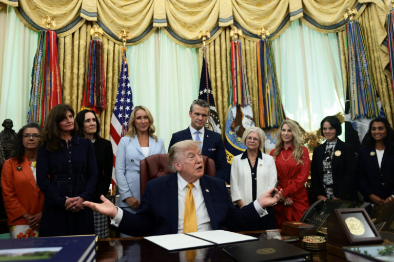 U.S. President Donald Trump signs an executive order in the Oval Office at the White House in Washington