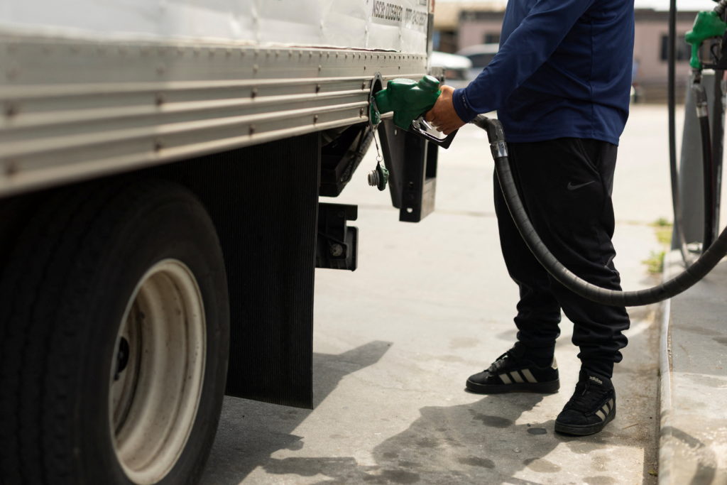A worker fills his truck with diesel fuel at a corporate filling station in California