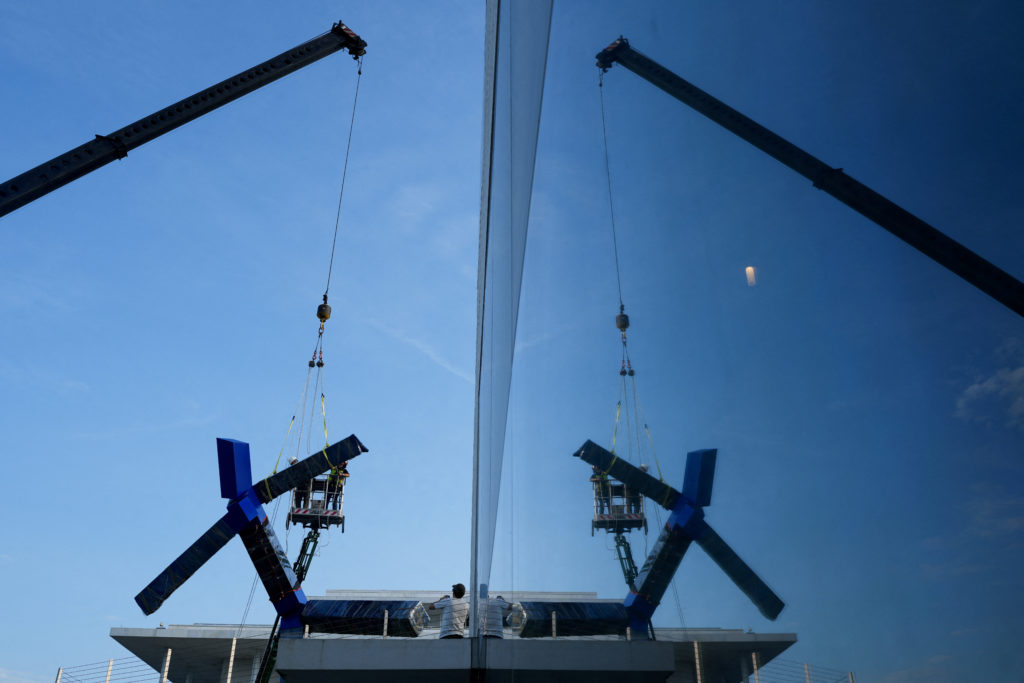 Crews work to remove the sculpture titled "Blue" by artist Joel Shapiro from the grounds of the Kennedy Center for the Per...