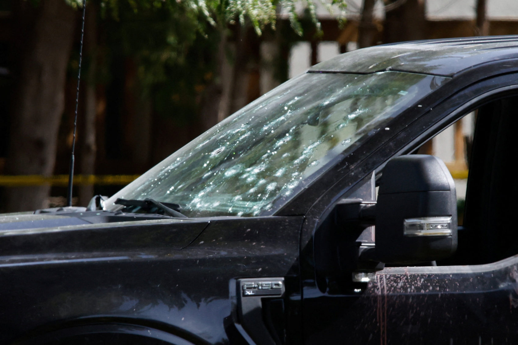 A truck window damaged by gunfire at the scene of a shooting where a police officer was shot outside a Yom Kippur gatherin...