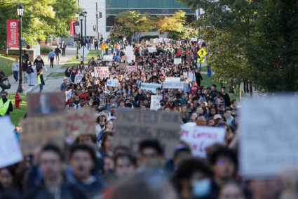 People attend a Justice for Survivors rally on at Cornell University in Ithaca, New York